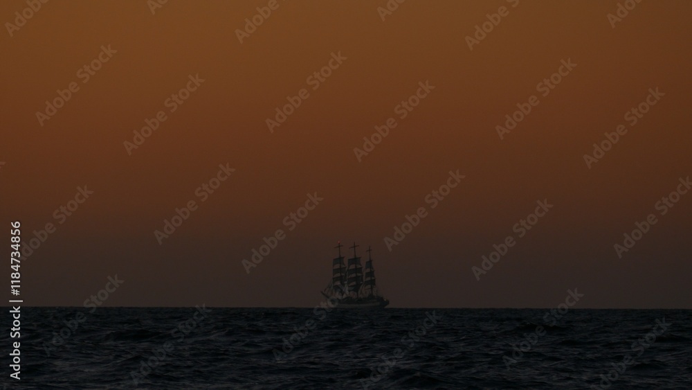 Fototapeta premium background - tall ship in the ocean after sunset