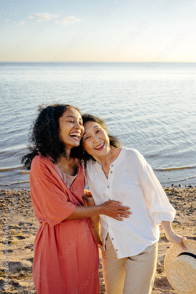 Mother and daughter laughing on beach Mother and daughter laughing on beach