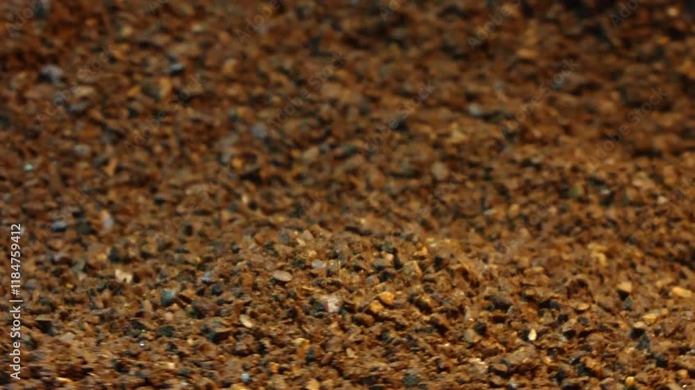 Coffee grounds rotating macro with falling grounds in selective focus. Background or design element. Coffee grounds rotating macro with falling grounds in selective focus. Background or design element.
