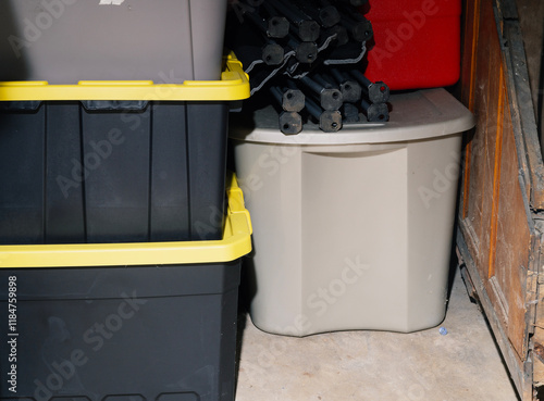 Plastic storage bins stacked in dusty basement cellar photo