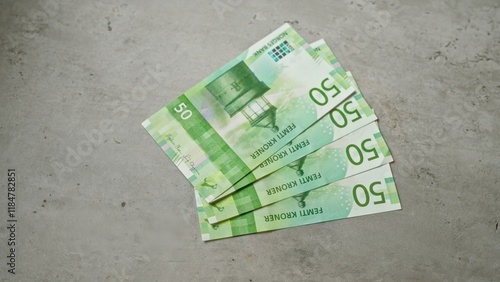 Bild auf Leinwand Norwegian 50 kroner banknotes spread on concrete background, showcasing norwegian currency in a neutral setting