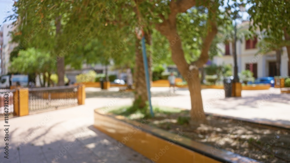 Defocused outdoor scene with trees and blurred background showing a park on a sunny day Defocused outdoor scene with trees and blurred background showing a park on a sunny day