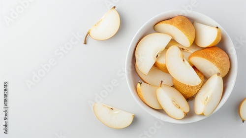 White bowl of sliced fresh pears on a white background, minimalistic fruit composition, isolated healthy snack, juicy organic produce, top view with copy space

