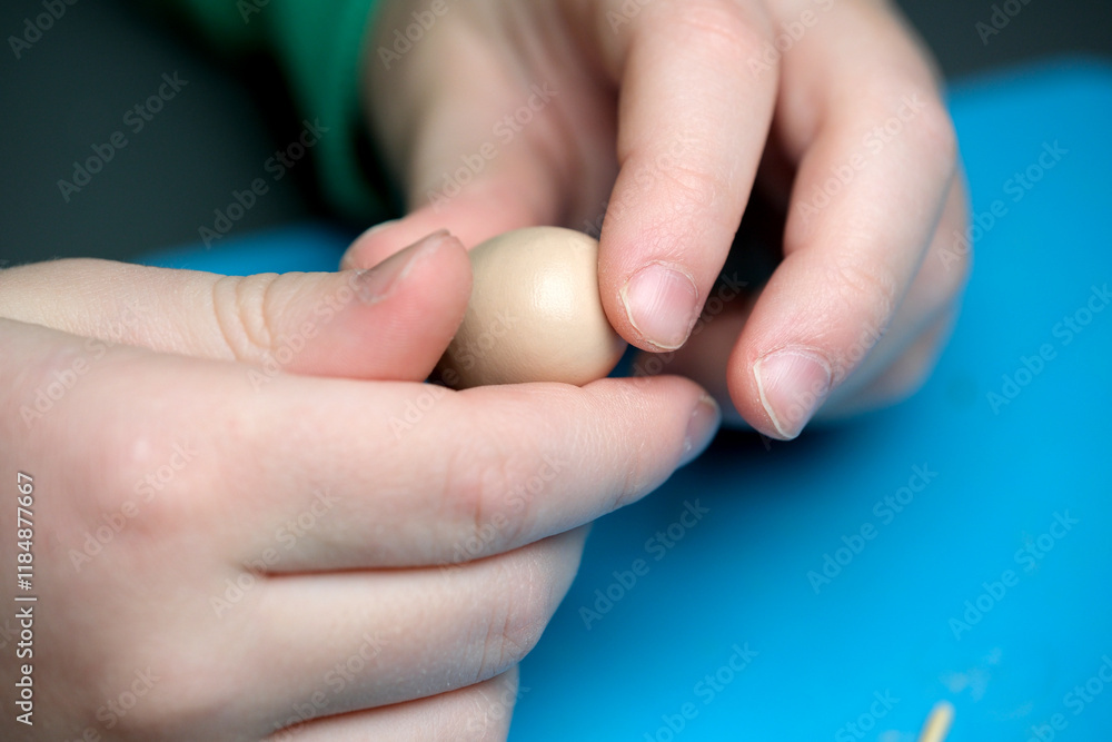 Crafting small wonders with hands on a vibrant blue workspace Crafting small wonders with hands on a vibrant blue workspace