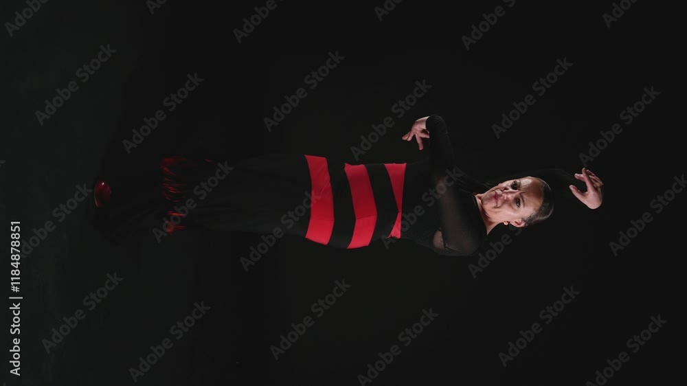 dramatic vertical portrait of a gypsy dancer in a red and black striped dress