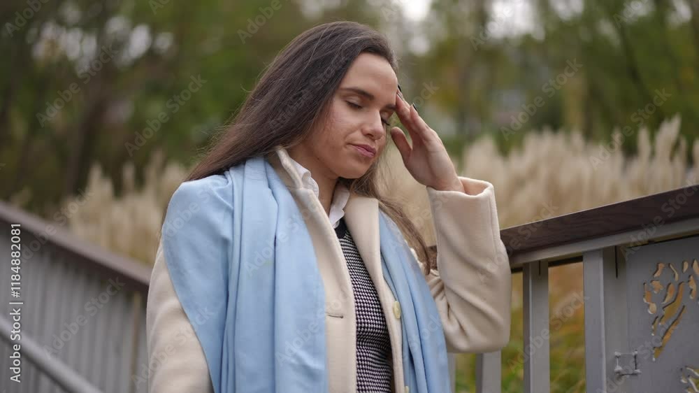 In a serene outdoor setting, a fashionable young woman engages in a phone conversation, displaying elegance In a serene outdoor setting, a fashionable young woman engages in a phone conversation, displaying elegance
