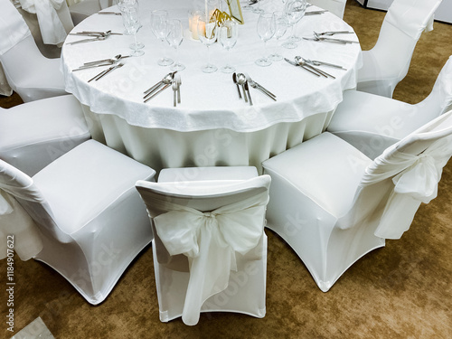 A wellarranged table with stylish, comfortable chairs creates an elegant atmosphere for a wedding reception, encouraging guests to enjoy the joyous celebration together photo