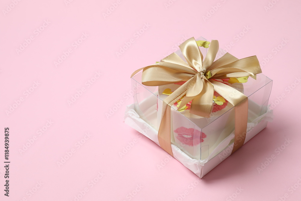 Colorful bento cake packed in a box with a bow on color background Colorful bento cake packed in a box with a bow on color background