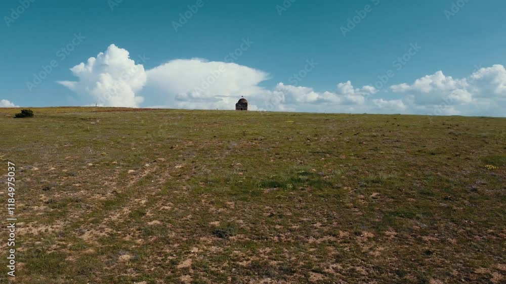 Impressive drone image of the historical Sungur Bey Tomb rising in the middle of the Konya plain. The clouds and the wide plain emphasize the solitude and historical importance of the tomb. Impressive drone image of the historical Sungur Bey Tomb rising in the middle of the Konya plain. The clouds and the wide plain emphasize the solitude and historical importance of the tomb.