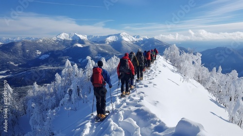 Hikers walking in line on snowy mountain ridge in winter