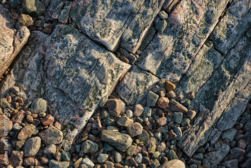 Sloping rock texture and pebbles below photo