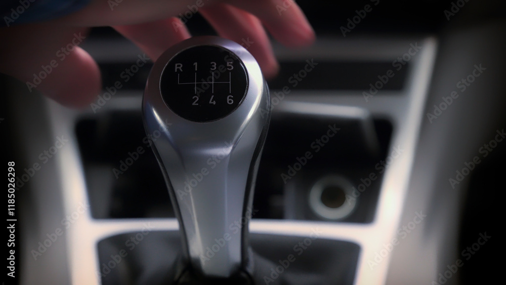 Driver changing gear with manual transmission gear stick