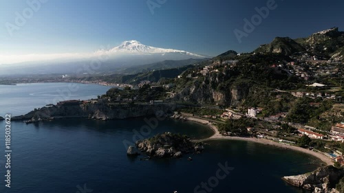 Aerial drone video series showcasing Taormina, Sicily, with views of the Mediterranean Sea, Isola Bella, the charming town, and the snow-capped peak of Mount Etna. Perfect for travel and tourism 