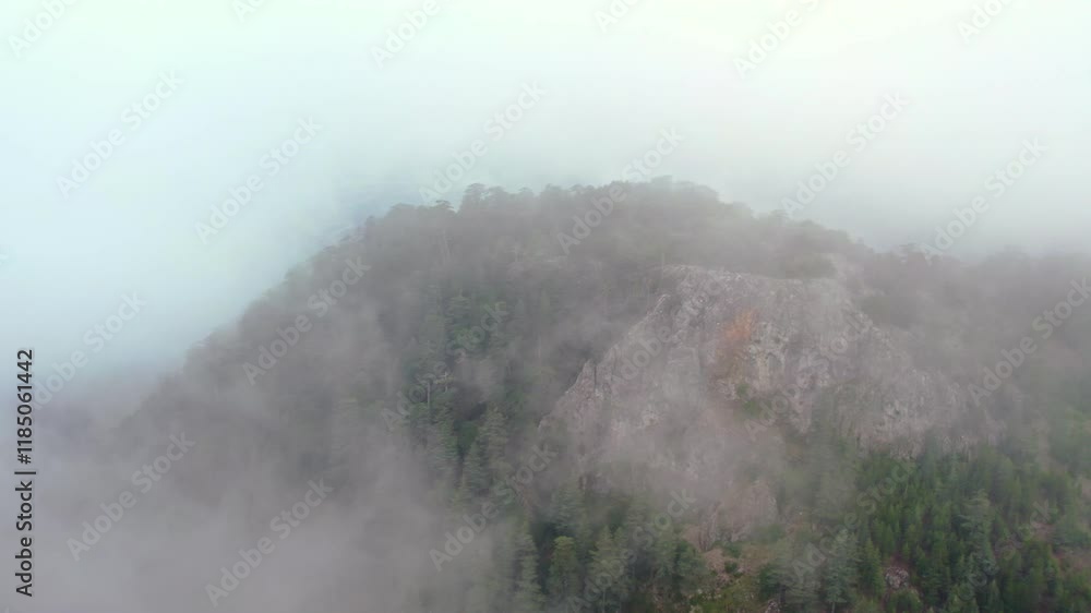 Aerial view of Burdur's Karanlık Dere,a serene landscape with soft, misty clouds,over green hills, revealing small patches of land through the delicate cloud cover,creating a tranquil atmosphere. Aerial view of Burdur's Karanlık Dere,a serene landscape with soft, misty clouds,over green hills, revealing small patches of land through the delicate cloud cover,creating a tranquil atmosphere.