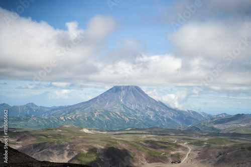 Vilyuchinsky Volcano, Kamchatka region. A breathtaking and stunning view of a magnificent volcano set amidst dramatic clouds and vibrant, lush landscapes photo