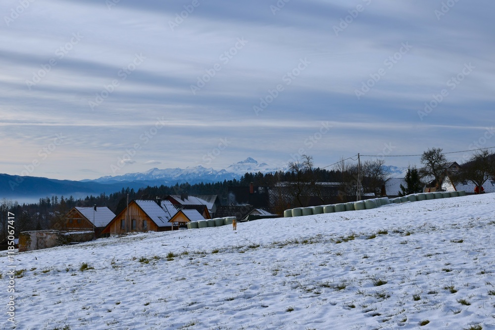 View of Povlje village and Triglav mountain behind in Gorenjska, Slovenia View of Povlje village and Triglav mountain behind in Gorenjska, Slovenia