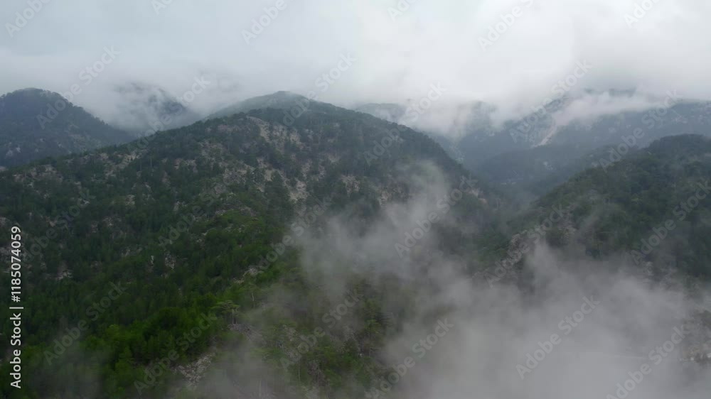 Aerial view of Burdur's Karanlık Dere,a serene landscape with soft, misty clouds,over green hills, revealing small patches of land through the delicate cloud cover,creating a tranquil atmosphere. Aerial view of Burdur's Karanlık Dere,a serene landscape with soft, misty clouds,over green hills, revealing small patches of land through the delicate cloud cover,creating a tranquil atmosphere.