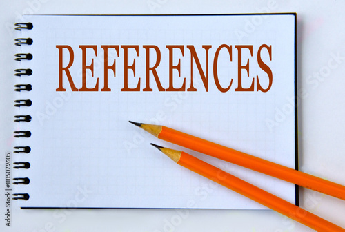 REFERENCES - word in notebook on white background with pencils