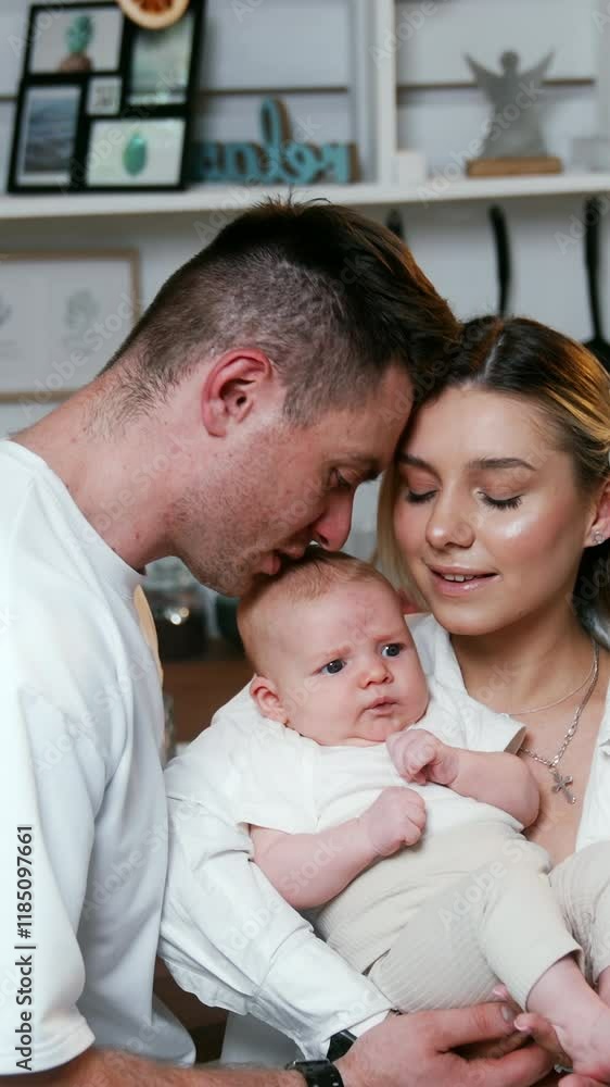 Newly-made parents holding a tiny newborn baby. Happy family moment of love and togetherness. Vertical video Newly-made parents holding a tiny newborn baby. Happy family moment of love and togetherness. Vertical video