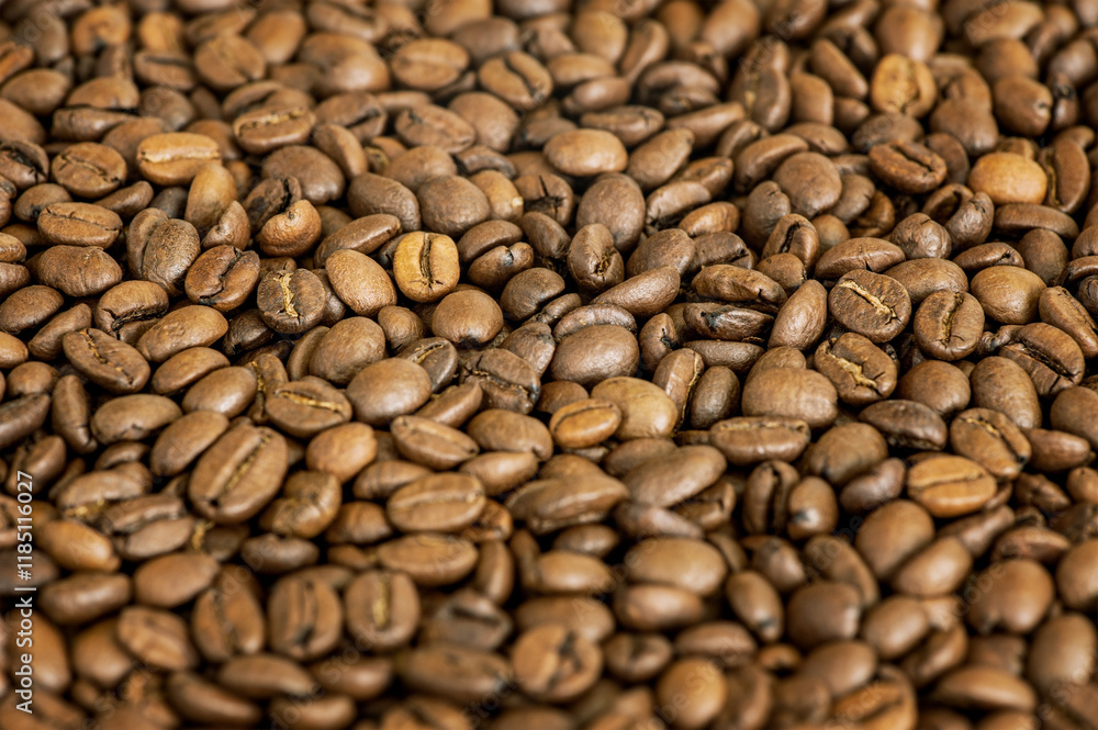 Close-up of roasted coffee beans forming a textured background. Perfect for concepts related to coffee production Close-up of roasted coffee beans forming a textured background. Perfect for concepts related to coffee production