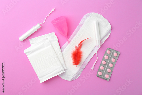 Flat lay composition with menstrual products on violet background photo