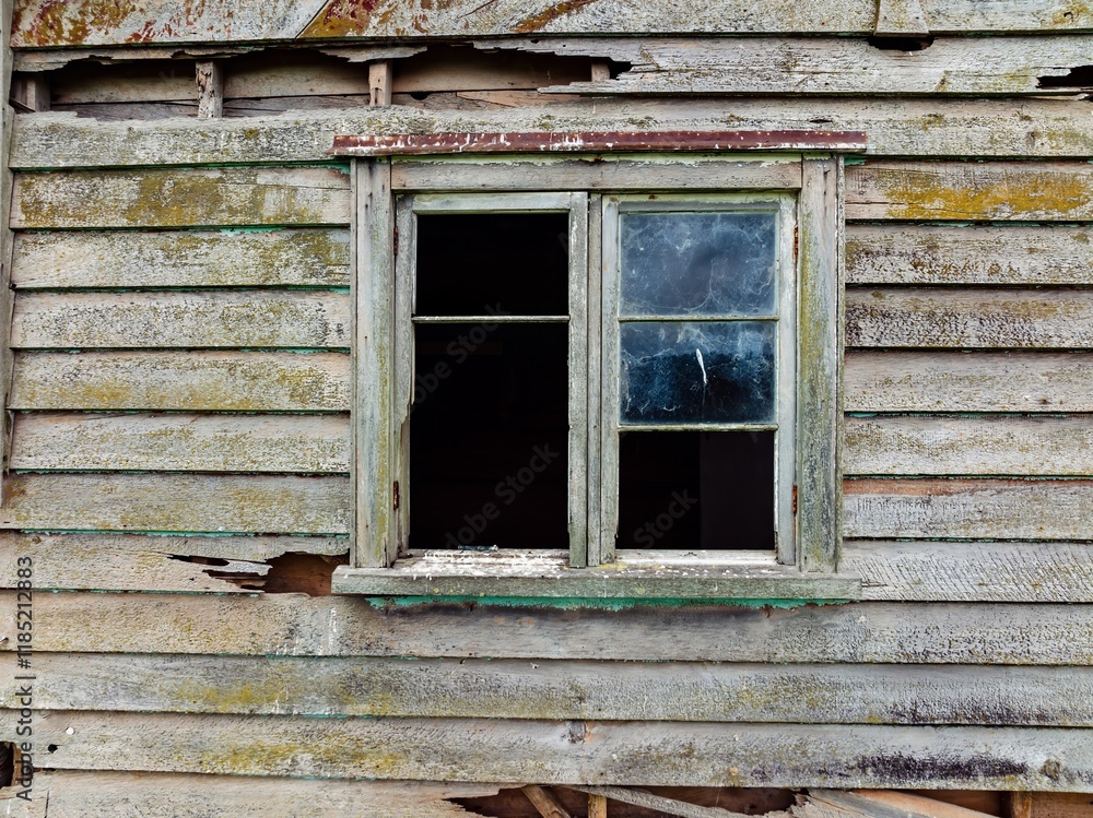 Decaying wooden window on an old weathered house. Time's ravages are evident. A testament to the past. TE KOPURU, NORTHLAND, NEW ZEALAND Decaying wooden window on an old weathered house. Time's ravages are evident. A testament to the past. TE KOPURU, NORTHLAND, NEW ZEALAND