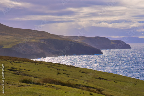 Arranmore Island in Donegal IrelandA serene view of picturesque lakes nestled in moorland, gracefully surrounded by gentle hills beneath a captivating sky photo