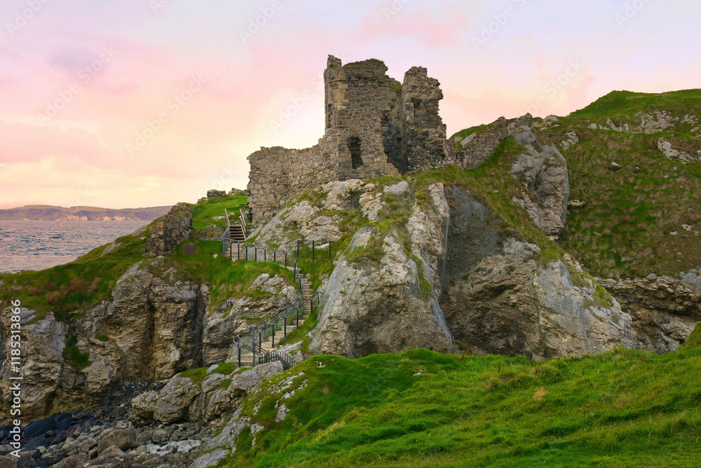 Kinbane Castle in Northern Ireland - A stunning and breathtaking view of a wild, rugged shore showcasing ancient ruins alongside beautiful ocean waves Kinbane Castle in Northern Ireland - A stunning and breathtaking view of a wild, rugged shore showcasing ancient ruins alongside beautiful ocean waves