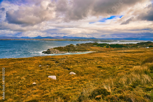 Arranmore Island in Donegal IrelandA serene view of picturesque lakes nestled in moorland, gracefully surrounded by gentle hills beneath a captivating sky photo