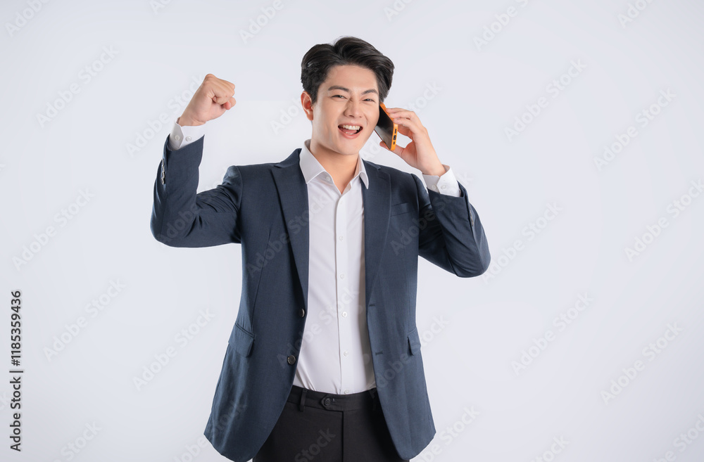 Portrait of young Asian business man using phone and posing on white background Portrait of young Asian business man using phone and posing on white background