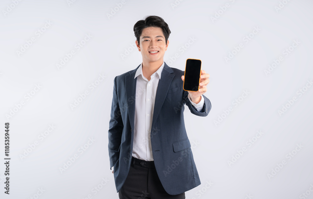 Portrait of young Asian business man using phone and posing on white background Portrait of young Asian business man using phone and posing on white background
