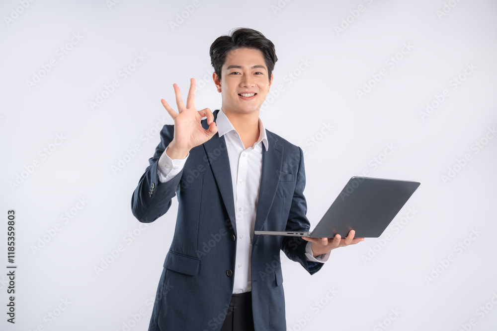 Portrait of young Asian business man using laptop and posing on white background Portrait of young Asian business man using laptop and posing on white background