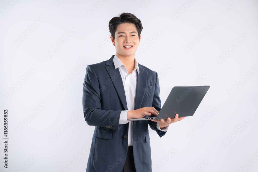 Portrait of young Asian business man using laptop and posing on white background Portrait of young Asian business man using laptop and posing on white background