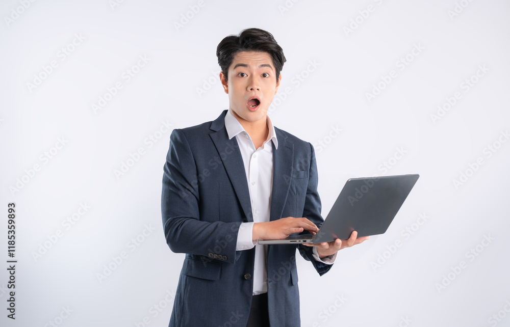 Portrait of young Asian business man using laptop and posing on white background Portrait of young Asian business man using laptop and posing on white background