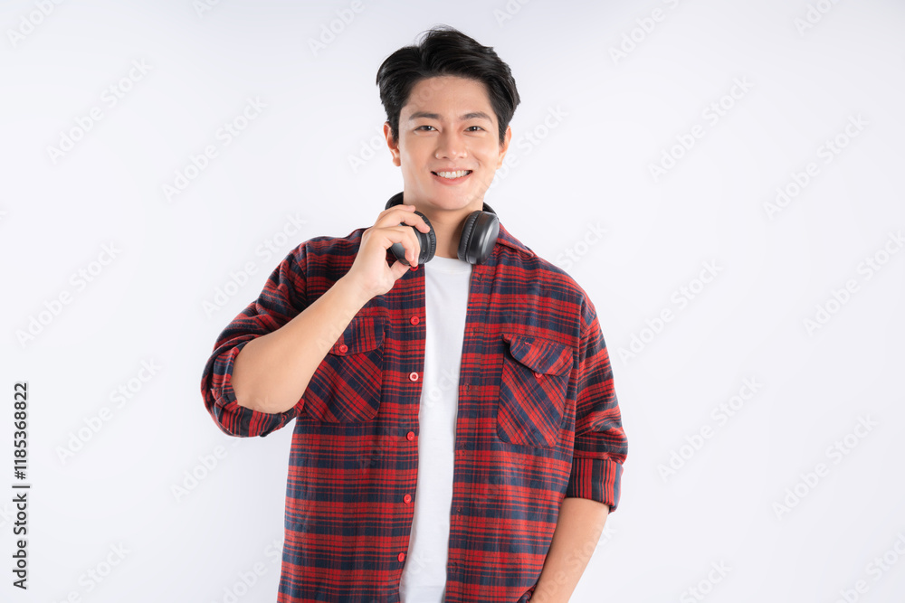 Portrait of dynamic Asian guy wearing headphones and posing on white background
Portrait of dynamic Asian guy wearing headphones and posing on white background