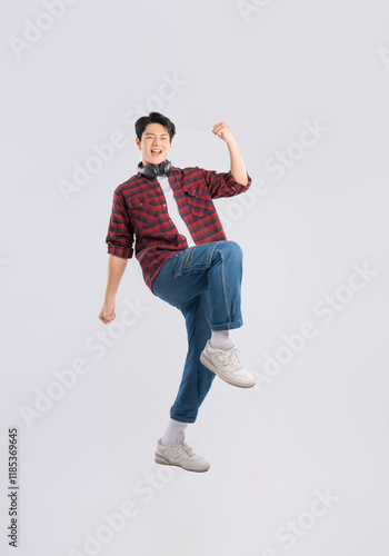 Full body image of young dynamic Asian man posing on white backgroundmage photo