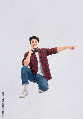 Full body image of young dynamic Asian man posing on white backgroundge photo