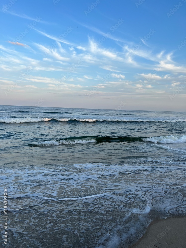 Calm ocean waves in the summer before sunset Calm ocean waves in the summer before sunset