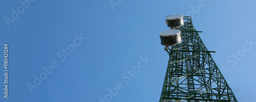 Communication tower top. Radio antenna Tower , microwave antenna tower on light sky background. wireless technology concept. communication