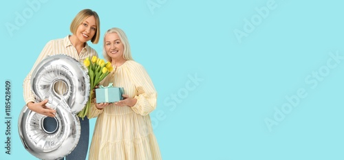 Woman and her mother holdin...