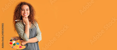 Beautiful female African-American artist on color background