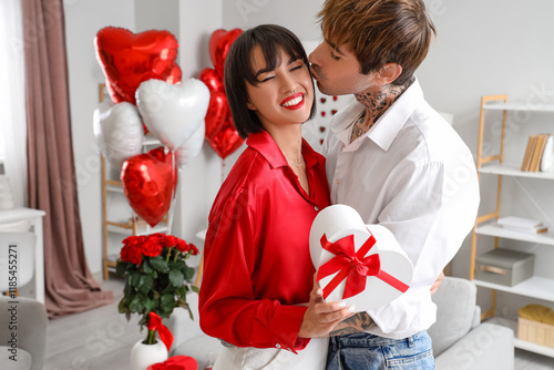 Young couple with gift kiss...
