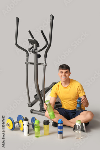 Young man with bottles of w...