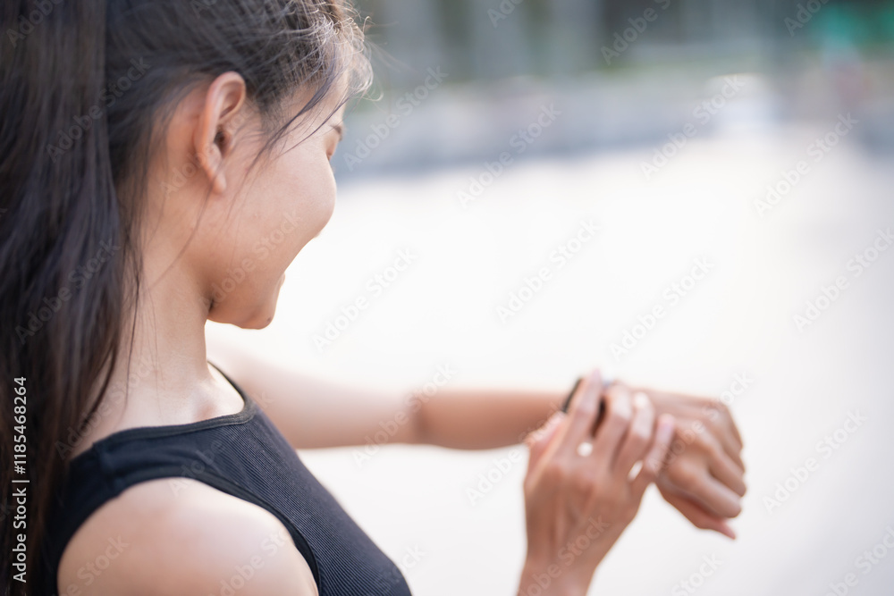 Sporty asian woman checking pulse in smart watch in sportswear workout with health app on smart watch After Exercise wellness health sportswoman Sporty asian woman checking pulse in smart watch in sportswear workout with health app on smart watch After Exercise wellness health sportswoman