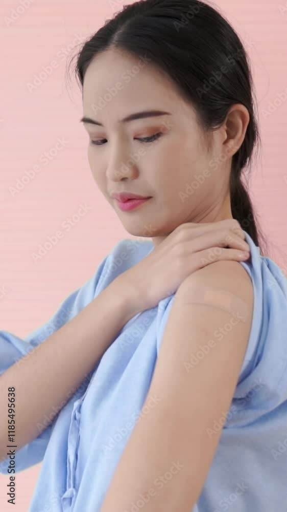 Young Asian woman showing COVID-19 vaccine bandage merrily in concept of coronavirus vaccination program to vaccinate citizen . Young Asian woman showing COVID-19 vaccine bandage merrily in concept of coronavirus vaccination program to vaccinate citizen .