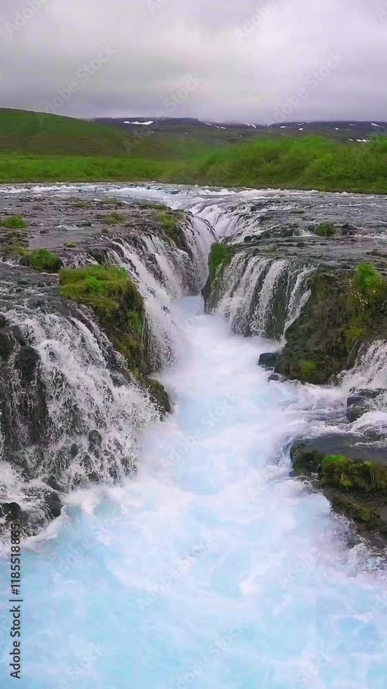 Drone aerial view of Bruarfoss waterfall landscape in Brekkuskogur, Iceland. Bruarfoss waterfall is the famous waterfall attracting tourist who visit route of Iceland Golden Circle. Drone aerial view of Bruarfoss waterfall landscape in Brekkuskogur, Iceland. Bruarfoss waterfall is the famous waterfall attracting tourist who visit route of Iceland Golden Circle.