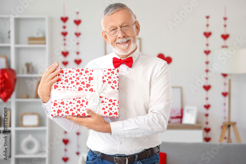 Happy mature man with gift ...