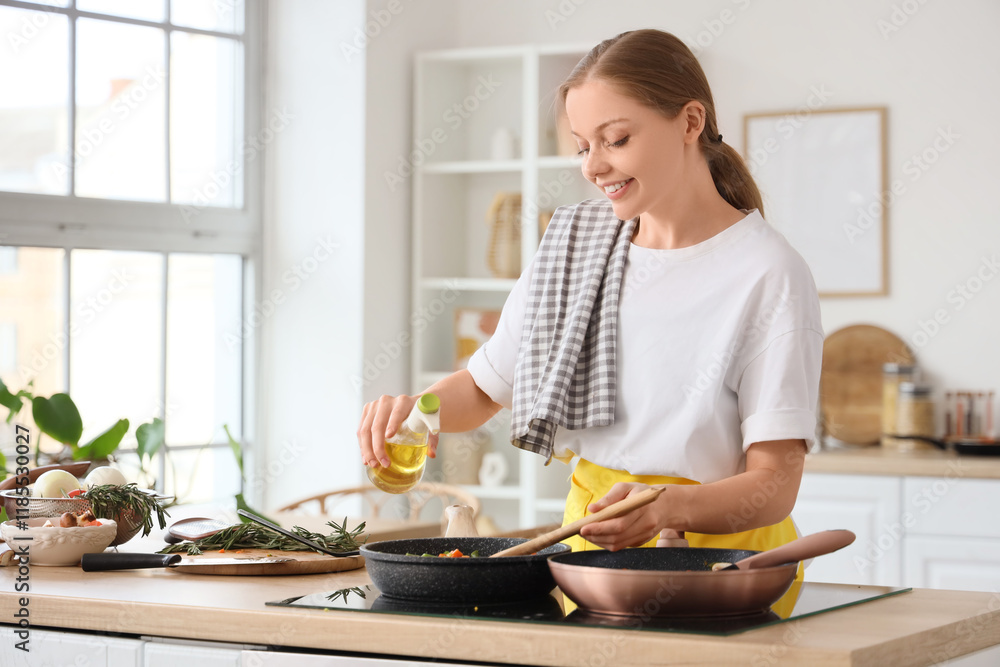 Young housewife pouring oil into fried vegetables in kitchen Young housewife pouring oil into fried vegetables in kitchen