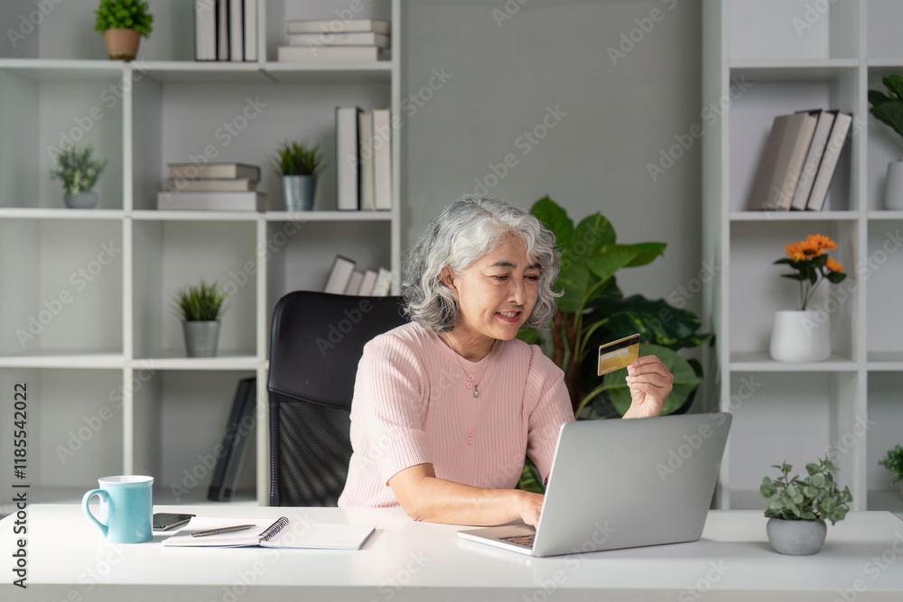Elderly woman shopping online with credit card at home office cozy environment senior lifestyle perspective Elderly woman shopping online with credit card at home office cozy environment senior lifestyle perspective