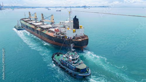 Obraz na plátne Cargo Ship was pulling by Tugboat go to Maintenance port